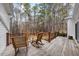 Charming deck with rocking chairs overlooking scenic wooded backyard at 208 Hunting Lodge Rd, Clayton, NC 27520