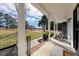 Cozy front porch with rocking chairs, offering a relaxing outdoor space with scenic views at 208 Hunting Lodge Rd, Clayton, NC 27520