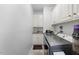 Bright laundry room with white cabinets, granite sink, and modern washer and dryer at 208 Hunting Lodge Rd, Clayton, NC 27520