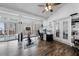 Bright sun room with wood floors, large windows, and access to the deck at 208 Hunting Lodge Rd, Clayton, NC 27520