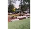 Dog park featuring grassy hills, logs, and various dogs enjoying the space at 228 Adams St, Cary, NC 27513