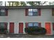 Two-story home featuring red shutters and doors, complemented by light-colored siding at 228 Adams St, Cary, NC 27513