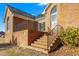 Brick stairs and a metal railing guide you up to the back patio with sliding glass door at 2318 Rogers Rd, Graham, NC 27253