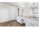 Bathroom featuring dual vanities with granite countertops and wood-look flooring at 2318 Rogers Rd, Graham, NC 27253