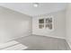 Bedroom with plush carpeting, large window, and neutral paint at 2318 Rogers Rd, Graham, NC 27253