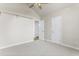 Neutral bedroom featuring a ceiling fan, plush carpet, and white trim at 2318 Rogers Rd, Graham, NC 27253