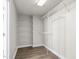 Walk-in closet with white shelving and wood floor, ready for storage at 2318 Rogers Rd, Graham, NC 27253
