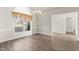 Dining room featuring hardwood floors, a decorative chandelier, wainscotting and natural light at 2318 Rogers Rd, Graham, NC 27253