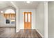 Bright entryway with a wooden front door, elegant flooring and a glimpse into the living area at 2318 Rogers Rd, Graham, NC 27253