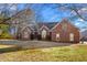 Charming single Gathering home featuring a classic brick exterior and well-maintained landscaping at 2318 Rogers Rd, Graham, NC 27253