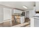 Bright kitchen boasts white cabinetry, stainless steel appliances, and an island with barstool seating at 2318 Rogers Rd, Graham, NC 27253