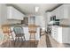 This well-lit kitchen includes stainless appliances, a breakfast bar, and wood-look flooring at 2318 Rogers Rd, Graham, NC 27253