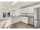 An open-concept kitchen features an island, stainless appliances, and access to an outdoor deck at 2318 Rogers Rd, Graham, NC 27253