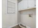Functional laundry room with white cabinets and connections for washer and dryer at 2318 Rogers Rd, Graham, NC 27253