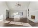 Cozy living room featuring hardwood floors, fireplace, built-in shelving and vaulted ceilings at 2318 Rogers Rd, Graham, NC 27253