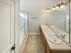 This is a full bathroom with a double sink, large mirror and shower/tub combo at 25 Scotch Bonnet Rdg, Clayton, NC 27520