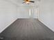 This is an empty bedroom with a gray carpet, tray ceiling, and a ceiling fan at 25 Scotch Bonnet Rdg, Clayton, NC 27520