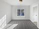 This bedroom boasts neutral walls, plush carpet, and a large window that allows for ample natural light at 25 Scotch Bonnet Rdg, Clayton, NC 27520
