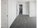 This hallway is designed with plush carpeting, neutral walls, and multiple doors leading to other areas of the house at 25 Scotch Bonnet Rdg, Clayton, NC 27520
