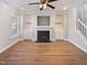 This is a living room with hardwood floors, fireplace, built-ins and staircase at 25 Scotch Bonnet Rdg, Clayton, NC 27520
