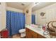 Cozy bathroom featuring a shower with curtain and a vanity with ample counter space at 2513 Drexall Ave, Durham, NC 27704