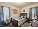 Cozy bedroom with plaid bedding, classic furniture, and soft natural light at 2513 Drexall Ave, Durham, NC 27704