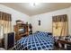 Bedroom with patterned bedding, functional furniture, and natural lighting at 2513 Drexall Ave, Durham, NC 27704