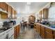 Bright kitchen featuring wood cabinets, white appliances, and view to dining area at 2513 Drexall Ave, Durham, NC 27704