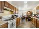 Open kitchen with ample cabinet space, white appliances, and dining area beyond at 2513 Drexall Ave, Durham, NC 27704