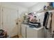 Well-lit laundry room equipped with a washer, dryer, and storage shelving at 2513 Drexall Ave, Durham, NC 27704