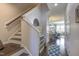 Inviting foyer with hardwood floors and staircase, leading to the living and dining areas at 304 Presenteer Trl, Apex, NC 27539