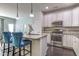 Modern kitchen with stainless steel appliances, granite countertops, and bar stool seating at 304 Presenteer Trl, Apex, NC 27539