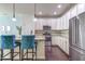 Bright kitchen with stainless steel appliances, a granite island, and white cabinetry at 304 Presenteer Trl, Apex, NC 27539