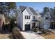 Beautiful two-story modern farmhouse with black garage door, metal roof, and manicured landscaping at 304 Shepherd St, Raleigh, NC 27607