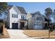 Beautiful new construction homes with a brick front porch, neutral color scheme, and attached garages at 304 Shepherd St, Raleigh, NC 27607