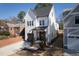 Charming two-story home with a brick front porch, black trimmed windows, and an attached garage at 304 Shepherd St, Raleigh, NC 27607