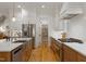 Modern kitchen featuring stainless steel appliances, a large island, and a view into a well-organized pantry at 304 Shepherd St, Raleigh, NC 27607