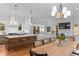 Open-concept kitchen and living area, featuring a central island, bar seating, and modern appliances at 304 Shepherd St, Raleigh, NC 27607