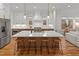 Modern kitchen with a large island, bar stool seating, and stainless steel appliances, open to the living area at 304 Shepherd St, Raleigh, NC 27607
