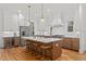 Well-appointed kitchen featuring a large center island, bar stool seating, and stainless steel appliances at 304 Shepherd St, Raleigh, NC 27607
