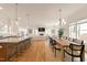 Open concept living room and dining area with wood floors, a fireplace, and plenty of natural light at 304 Shepherd St, Raleigh, NC 27607