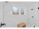 Modern shower showcasing luxurious tile work, a built-in bench, and dual shower heads at 304 Shepherd St, Raleigh, NC 27607
