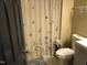 Bathroom featuring a butterfly shower curtain, white toilet, and tiled floor at 312 East End Ave, Durham, NC 27703