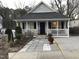 Charming single-story home with a covered front porch, a well-maintained lawn, and mature landscaping at 312 East End Ave, Durham, NC 27703