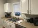 Bright kitchen featuring white cabinets, stainless steel sink, and modern appliances at 312 East End Ave, Durham, NC 27703