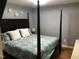 Serene bedroom featuring a four poster bed, plush bedding, and hardwood floors at 312 East End Ave, Durham, NC 27703