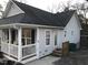 Cozy home featuring a porch, well-kept siding, and functional entry points at the side of the house at 312 East End Ave, Durham, NC 27703