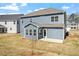Rear exterior view of the house featuring a patio and a spacious backyard at 319 N Maple Walk # 213, Garner, NC 27529
