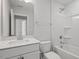 A well-lit bathroom featuring a vanity, mirror, tub, and shower combo at 319 N Maple Walk # 213, Garner, NC 27529