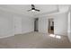 This bedroom has carpet, a ceiling fan, tray ceiling, and is open to the Primary bathroom at 319 N Maple Walk # 213, Garner, NC 27529